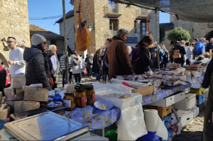 A photo of a stall of local cheeses at the autumn fair in Ainsa on our Spanish Language Walking Holiday Advanced Level