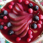 A gourmet dish of poached pears with berries on our Cooking Holidays Spain with Aragon Active part of a guest review