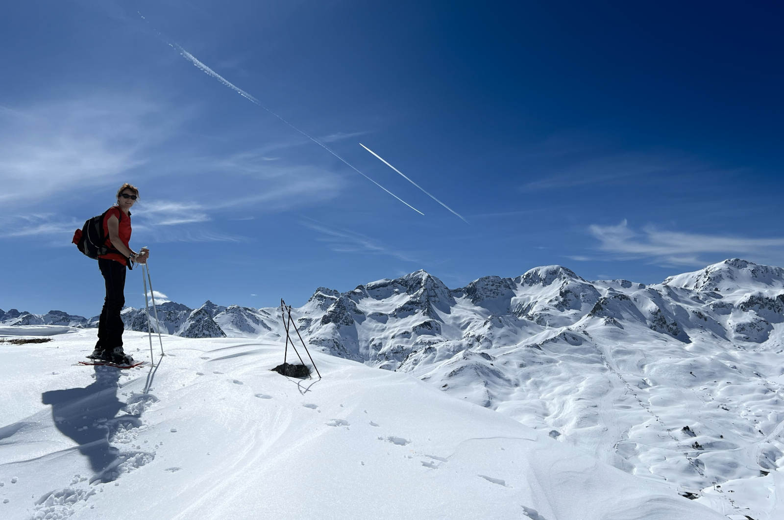 Lucy on the top of a mountain in snow shoes with panoramic views on our Snowshoeing Holiday Spain with Aragon Active small group holidays