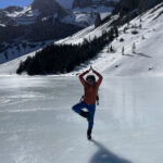 Our local guide doing yoga on a frozen lake on our Winter Walking and Snowshoeing Holiday Spain with Aragon Active small group holidays