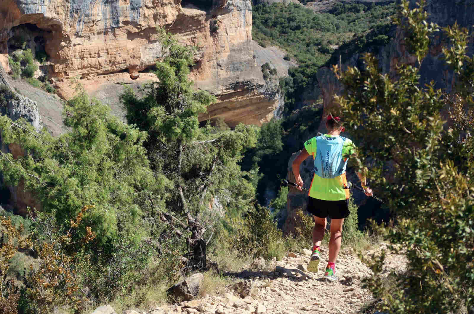 One female trail runner running down a rocky path way in the Sierra de Guara in the Pyrenees on our Trail Running Holidays with Aragon Active small group holidays