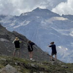 Hikers pointing at the features of the mountain with a guide in the Spanish Pyrenees on Walking Holidays in Spain with Aragon Active